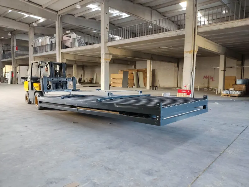 A flat-packed B2KON unit carried by a forklift in the factory